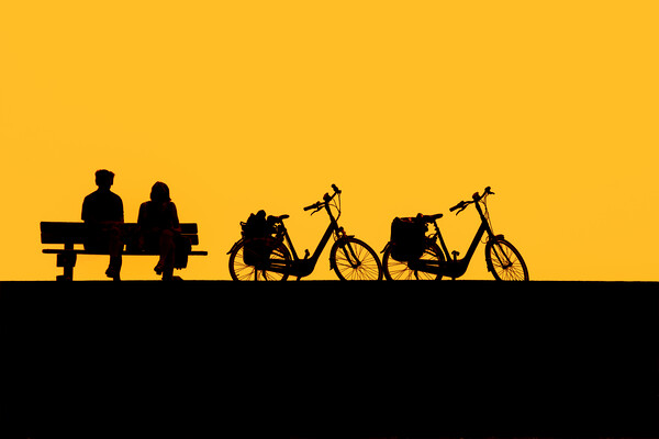 Resting Cyclists at Sunset Picture Board by Arterra 