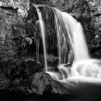 Buy canvas prints of Majestic Flowing Waterfall in Scottish Highlands by Jim Round
