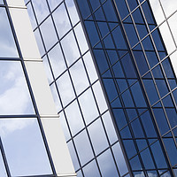 Buy canvas prints of Glass office building sky reflections by Joseph Clemson