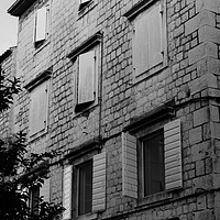 Buy canvas prints of Black and white building with windows and shutters by Barbara Vizhanyo