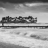 Buy canvas prints of A man walks along a jetty on a stormy day by George Cairns