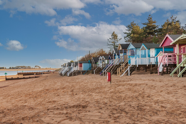 Vivid Beach Huts at WellsnexttheSea Picture Board by Kevin Snelling