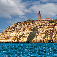 Buy canvas prints of Alfanzina lighthouse on the clifftop at Carvoeiro  by Kevin Snelling