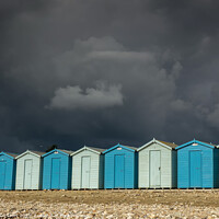 Buy canvas prints of Blue beach huts under a black sky by JUDI LION