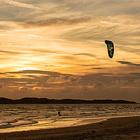 Buy canvas prints of Kite surfer riding along the tideline at sunset by JUDI LION