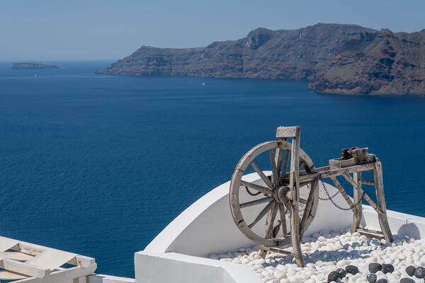 Spinning wheel over ocean on Santorini Picture Board by Steve Heap