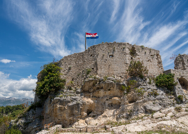 Flag on top of fortress above the Croatian town of Novigrad in I Picture Board by Steve Heap