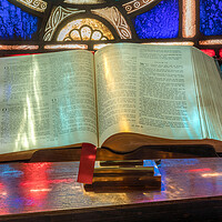 Buy canvas prints of Light from stained glass window falls on open bible in american  by Steve Heap