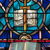 Buy canvas prints of Light from stained glass window falls on open bible in american  by Steve Heap