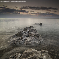 Buy canvas prints of Long exposure on shoreline rocks by Gary Parker