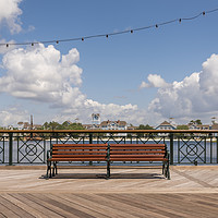 Buy canvas prints of Single public bench on a boardwalk by Gary Parker