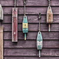 Buy canvas prints of Fishing floats hanging on a wooden wall by Gary Parker