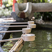 Buy canvas prints of Row of ceremonial water cups at Japanese temple by Gary Parker