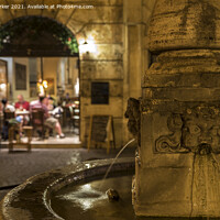 Buy canvas prints of Roman fountain, with a small Trattoria in the background, at night by Gary Parker
