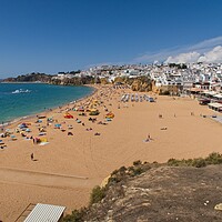 Buy canvas prints of Albufeira's Serene Beachfront and Heritage by Rob Cole
