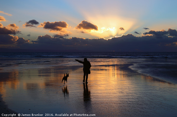 Walking the Dog at Sunset on Dunraven Bay Beach Picture Board by James Brunker