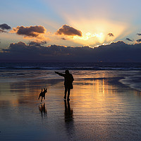 Buy canvas prints of Walking the Dog at Sunset on Dunraven Bay Beach by James Brunker