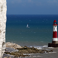 Buy canvas prints of Beachy Head Lighthouse and sailing boat by James Brunker