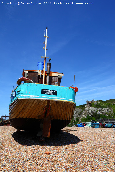 Fishing boat on the beach at Hastings Picture Board by James Brunker