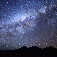 Buy canvas prints of Milky Way above the Payachatas Volcanos Bolivia by James Brunker