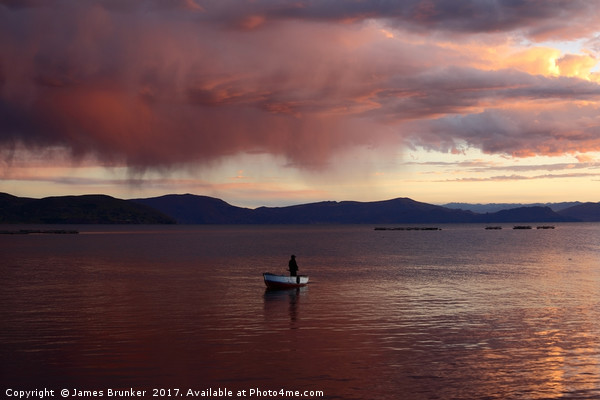 Stormy Sunset and Fisherman on Lake Titicaca Picture Board by James Brunker