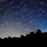 Buy canvas prints of Star Trails over Bonehill Rocks by Nymm Gratton
