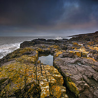 Buy canvas prints of Lichen Covered Rocks at Ogmore by Sea by Neil Holman