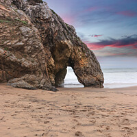 Buy canvas prints of Beautiful stone natural arche. Rock formation in a beach with ocean in background at the sunset by nuno valadas