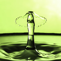 Buy canvas prints of water drop collision in green. by Paul Allen