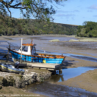 Buy canvas prints of A small fishing boat moored while the tide is out by Joy Walker