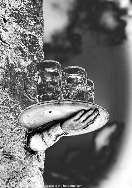 A model of a disconnected hand and beer glasses balanced on a tray Picture Board by Joy Walker