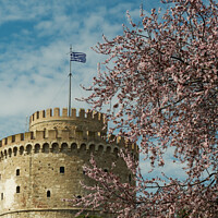 Buy canvas prints of Thessaloniki The White Tower on a spring day against blue sky with clouds.  by Theocharis Charitonidis
