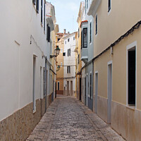 Buy canvas prints of Cobbled Street in Ciutadella by Philip Openshaw