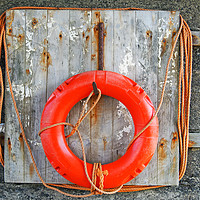 Buy canvas prints of life buoy on a weathered wooden board with faded o by Philip Openshaw
