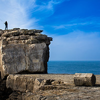 Buy canvas prints of Fisherman casting a rod on the coast cliff rock by André Jorge