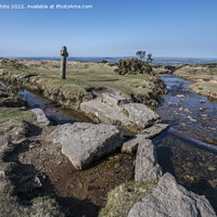 Buy canvas prints of Isolation by a Dartmoor stream with stone cross  by Kevin White