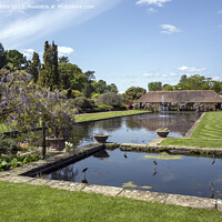 Buy canvas prints of Ponds view from old building at Wisley Gardens by Kevin White