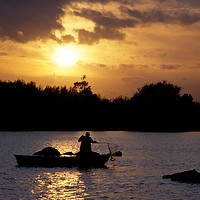 Buy canvas prints of Fishing in a boat at sunset. by Peter Hatter