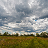 Buy canvas prints of Stormy clouds over meadow by Łukasz Szczepański