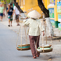 Buy canvas prints of Vietnamese woman carrying products by Łukasz Szczepański
