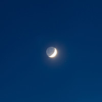 Buy canvas prints of Moon's grey light against blue starry sky backgrou by Łukasz Szczepański