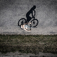 Buy canvas prints of Cyclist on the road, top down image of shadow on t by Łukasz Szczepański