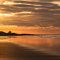 Buy canvas prints of Bamburgh Lighthouse at Sunset by Gary Clarricoates