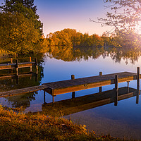 Buy canvas prints of Wooden Jetties on a Becalmed Lake at Sunset by Alan Hill