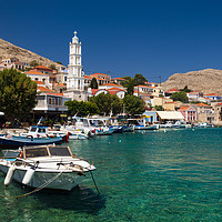 Buy canvas prints of Multi-coloured buildings of Halki Island by Alan Hill