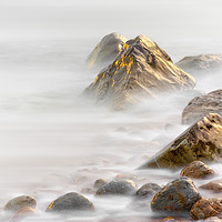 Buy canvas prints of Rocks at Osmington Reflecting Sunset Colours by Alan Hill