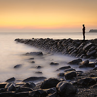 Buy canvas prints of Lone figure stands looking out to sea by Alan Hill