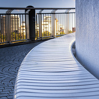 Buy canvas prints of Curved riverwalk seat in shade by Ian Leishman