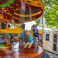Buy canvas prints of Fairground carousel ride blurred to show speed and movement with small child watching, London UK by Dave Collins