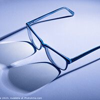 Buy canvas prints of Artistic blue toned pair of blue glasses with shadows by Dave Collins